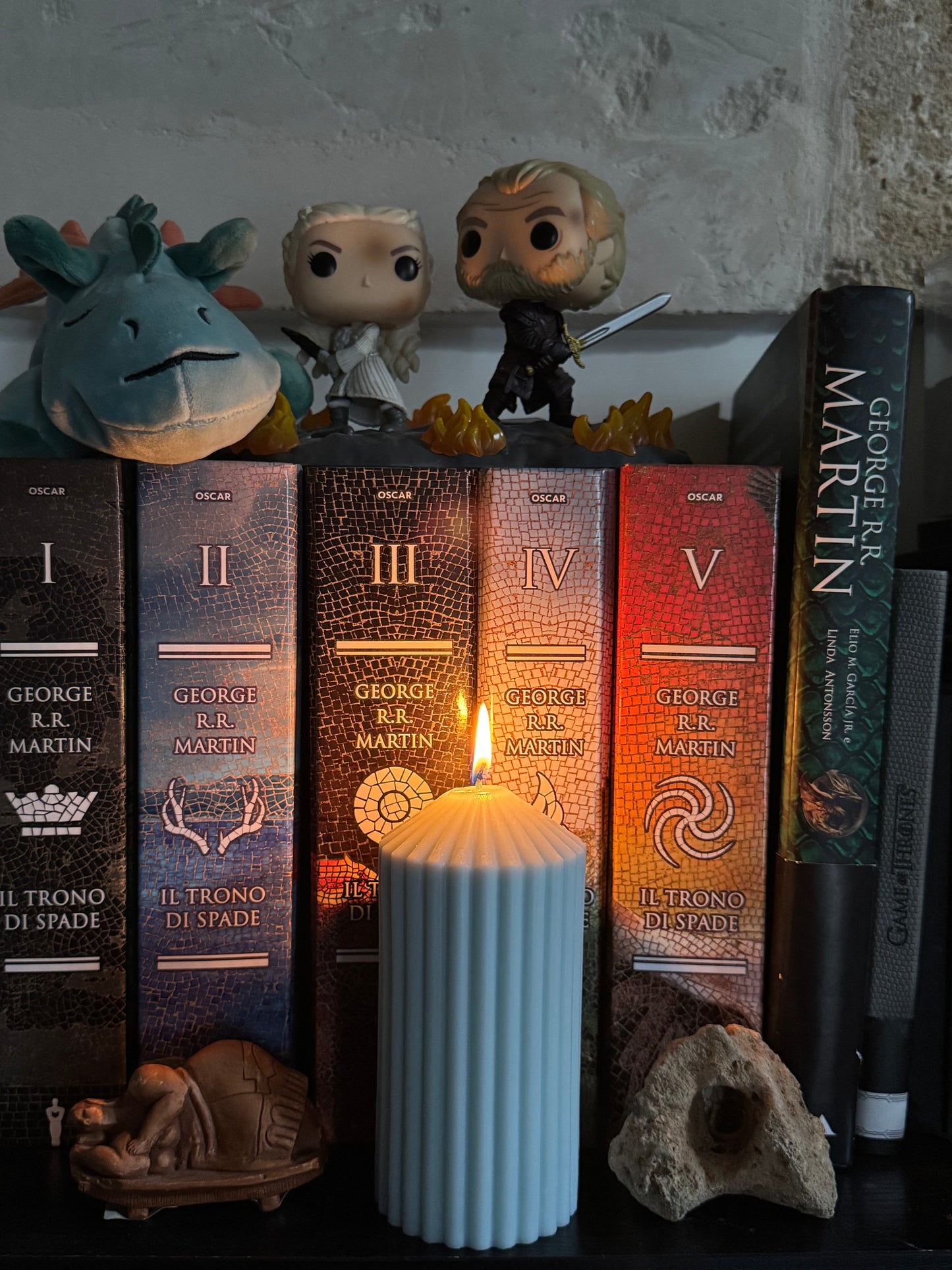 candela plissé accesa come elemento di arredo su libreria